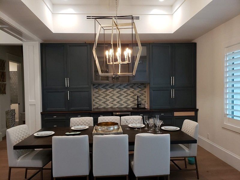 A dining room with a table and chairs and a chandelier
