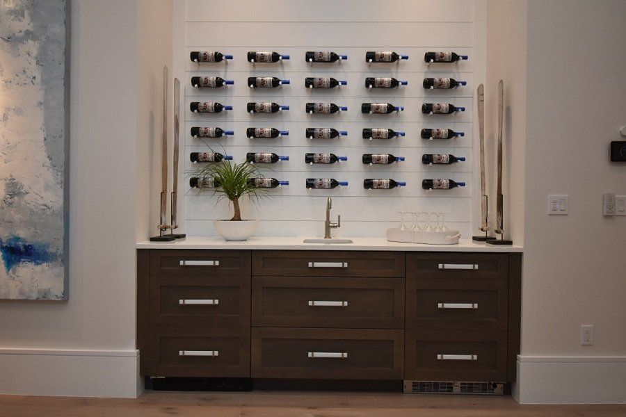A wine rack is hanging on the wall above a sink in a kitchen.