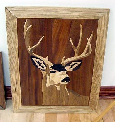 A picture of a deer in a wooden frame