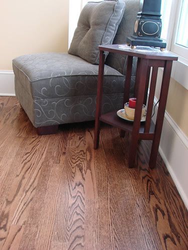 A chair is sitting next to a small table in a living room.