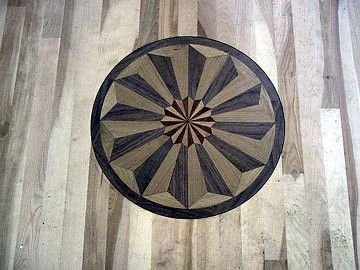 A wooden floor with a circular pattern on it