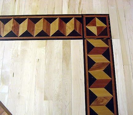 A wooden floor with a geometric pattern on it
