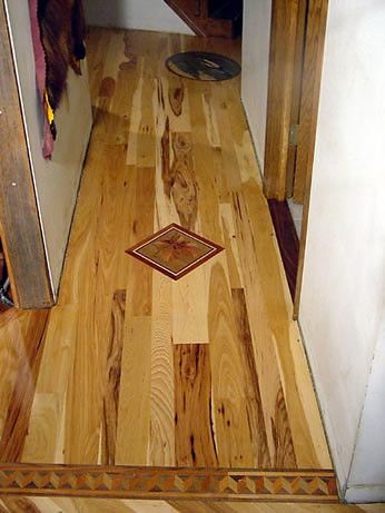 A wooden floor with a diamond pattern on it
