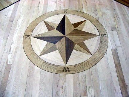 A wooden floor with a compass on it