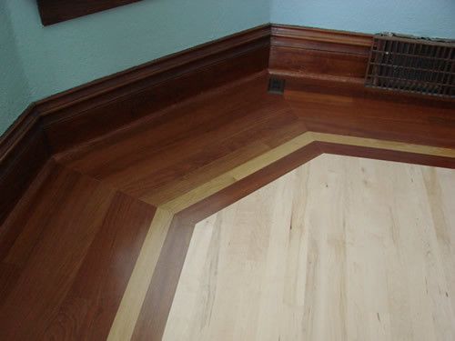 A room with a wooden floor and a window