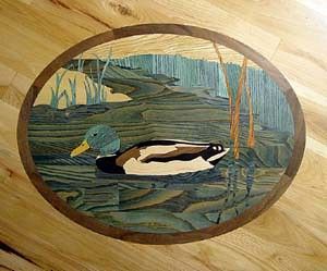 A wooden painting of a duck in a pond on a wooden table.