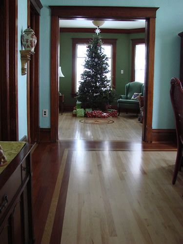 A living room with a christmas tree in the middle of it