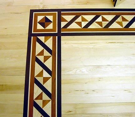 A wooden floor with a geometric pattern on it