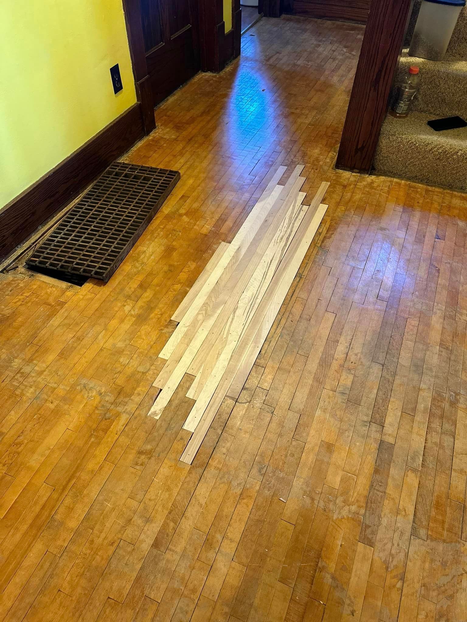 A wooden floor with a lot of tape on it.