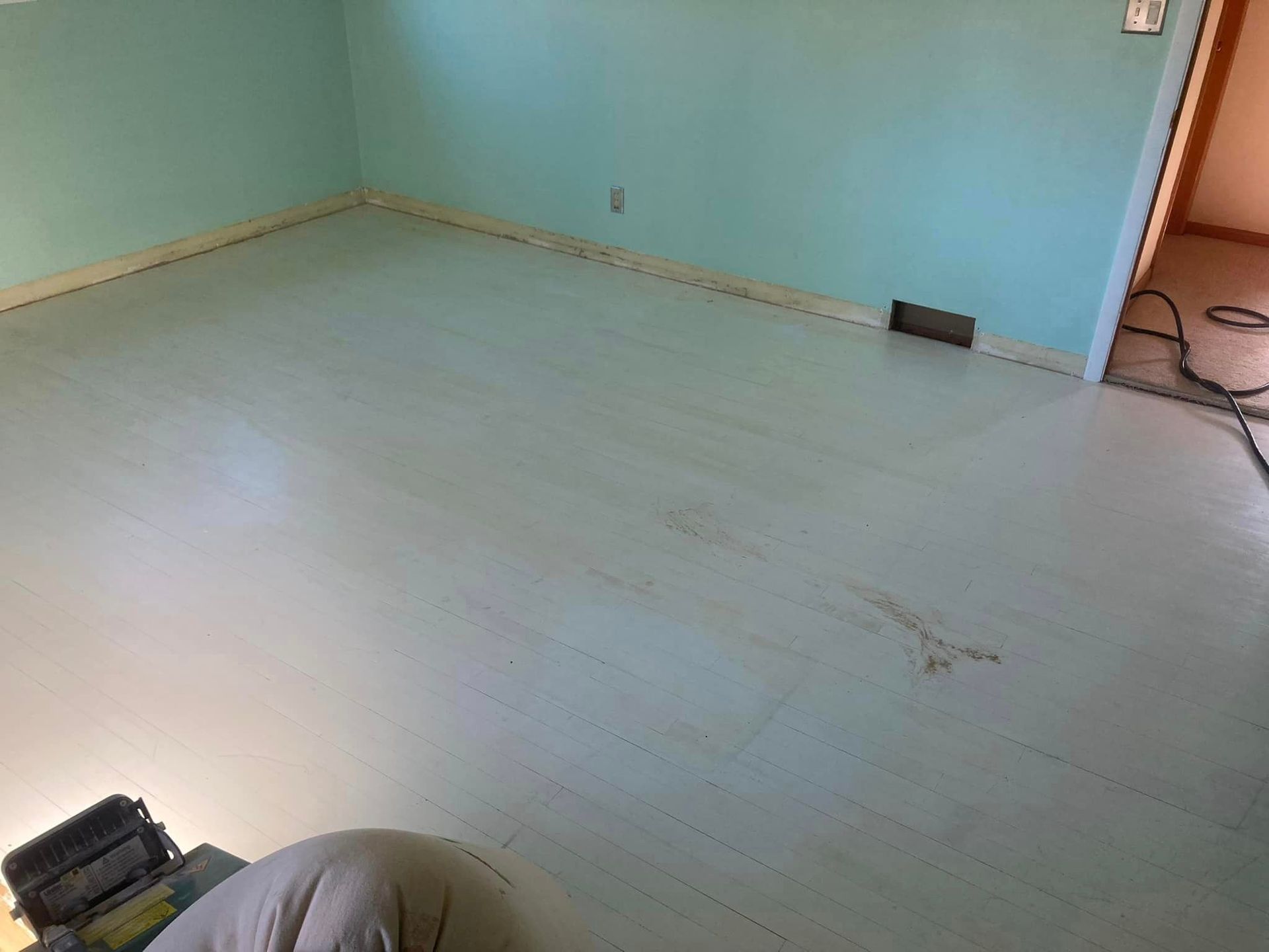 A room with a white floor and blue walls.