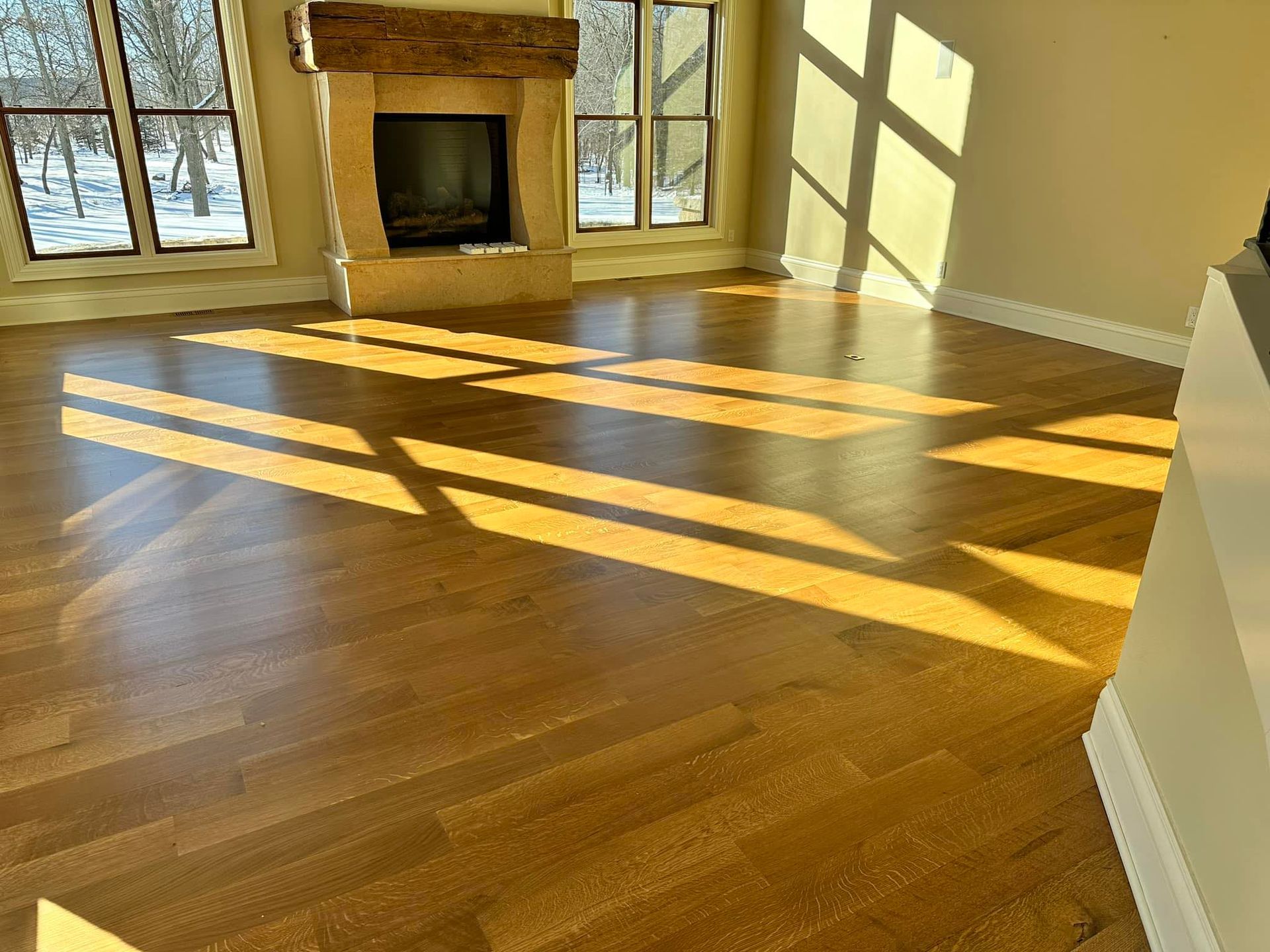 A living room with hardwood floors and a fireplace.