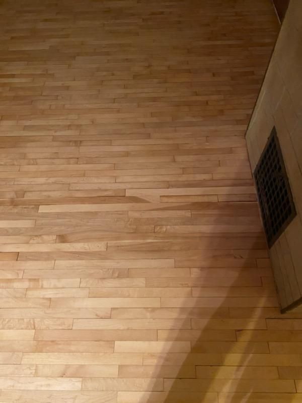A close up of a wooden floor in a room.