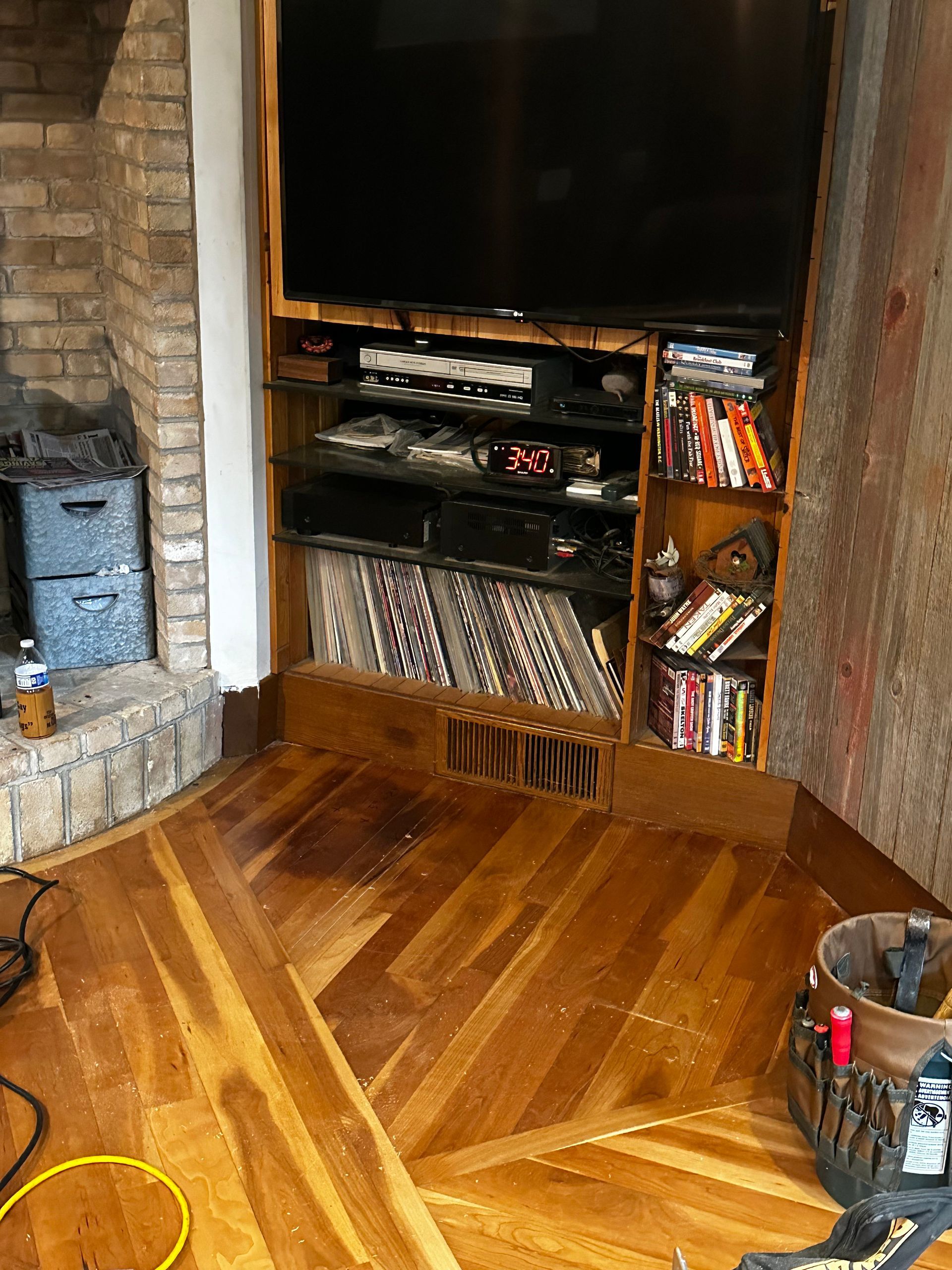 A living room with hardwood floors and a flat screen tv.