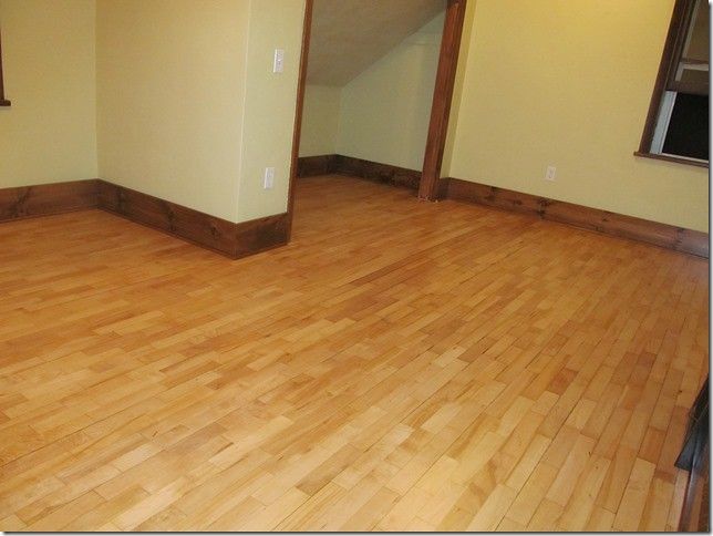 A room with a wooden floor and yellow walls