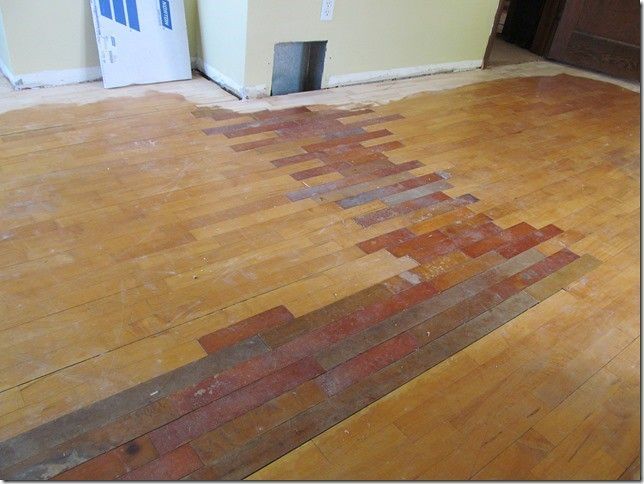 A wooden floor with a brick pattern on it