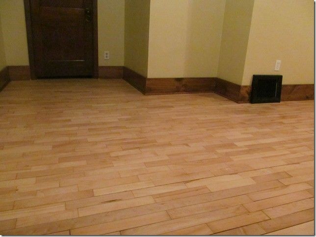 A room with a wooden floor and yellow walls