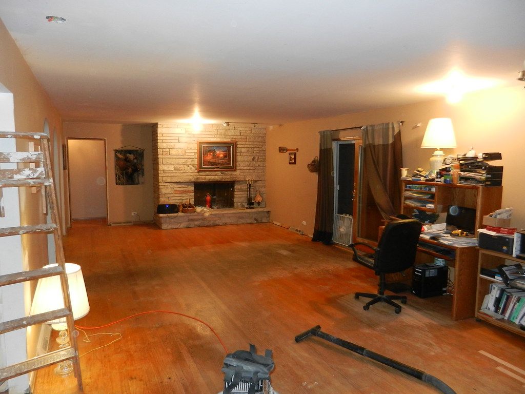 A living room with hardwood floors and a fireplace