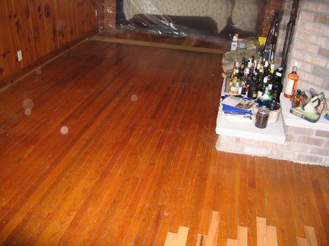 A living room with hardwood floors and a fireplace