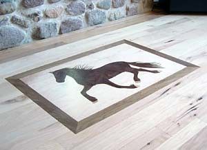 A wooden floor with a picture of a horse on it.