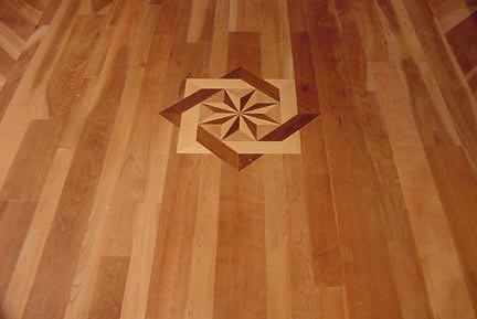 A wooden floor with a geometric pattern on it
