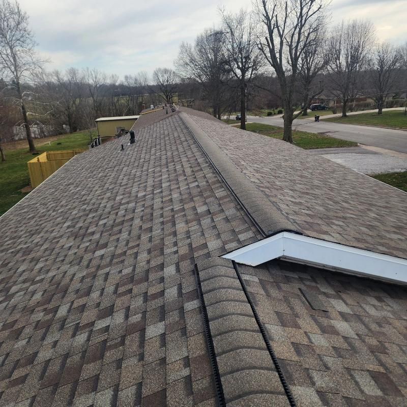 A roof with shingles and a skylight on it