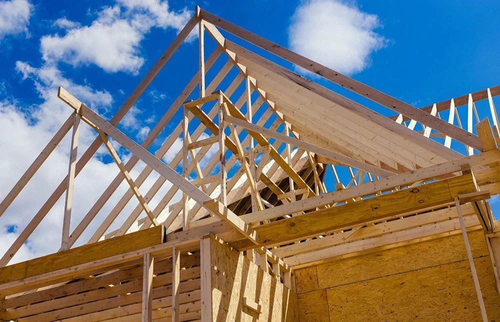 A house is being built with a blue sky in the background.