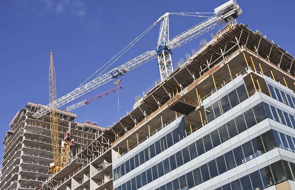 A building under construction with a crane on top of it