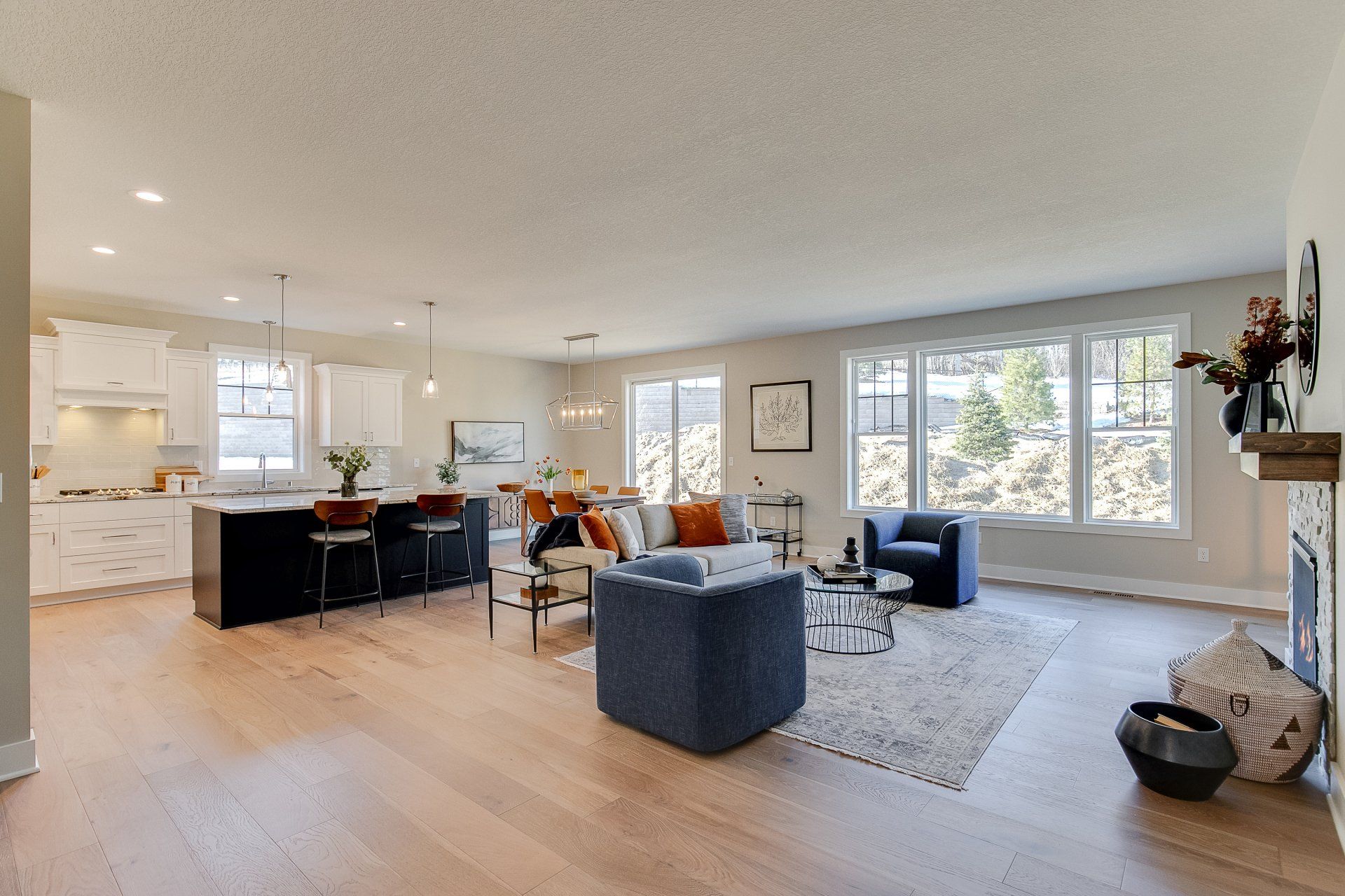 A living room filled with furniture and a fireplace in a house.