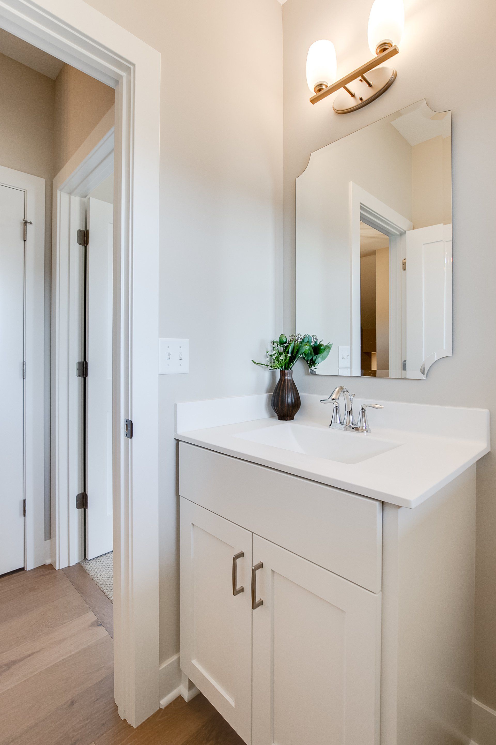 A bathroom with a sink and a mirror.