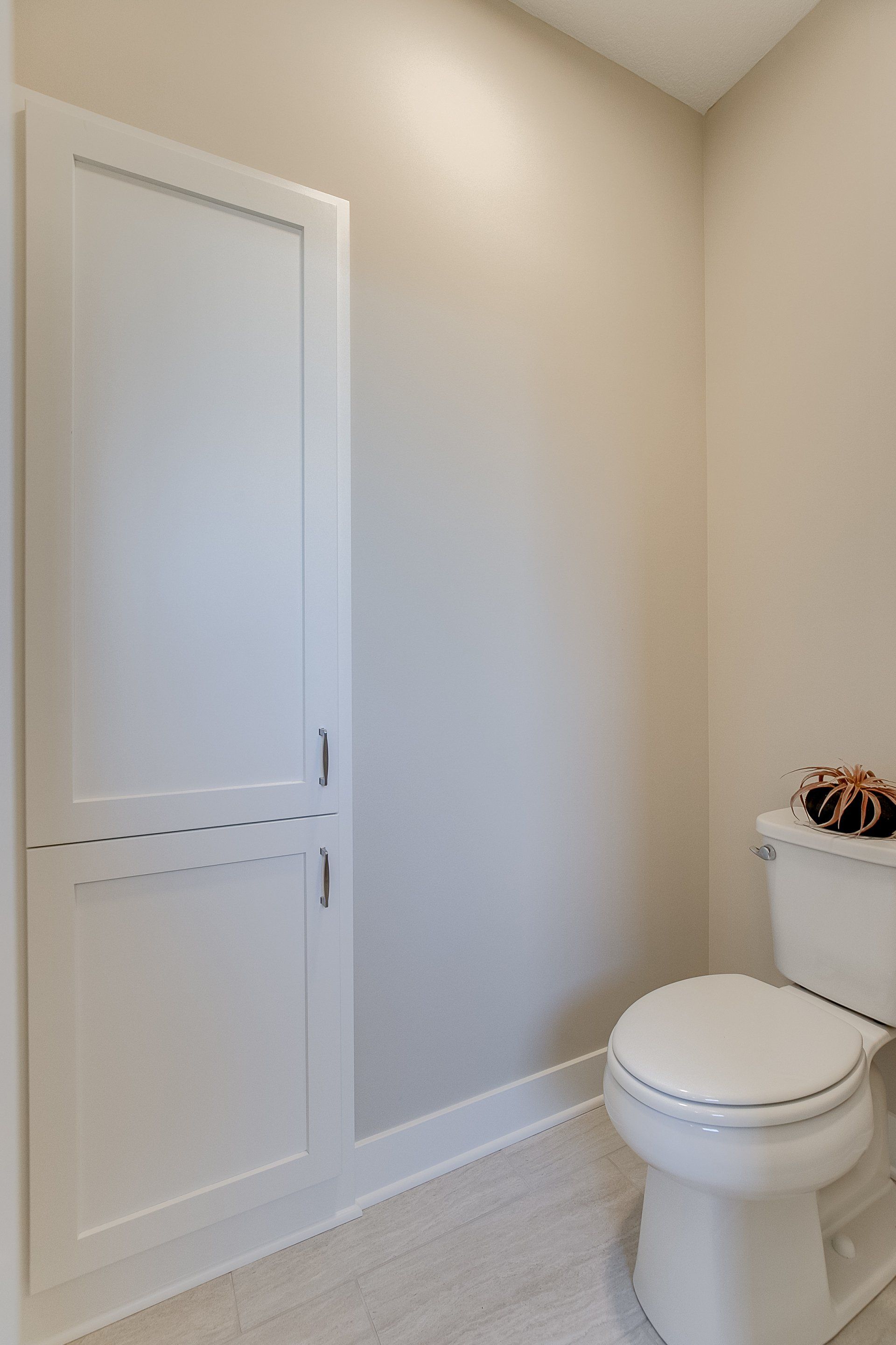 A bathroom with a toilet and a white door