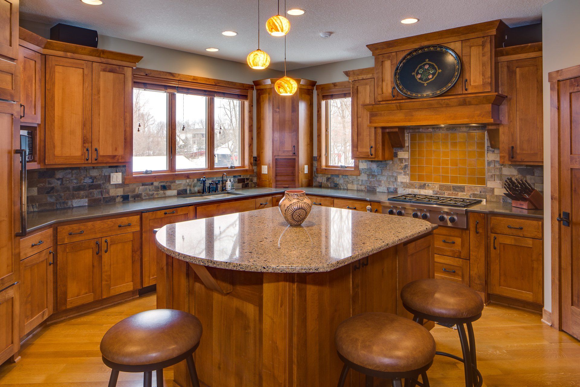 A kitchen with wooden cabinets and granite counter tops