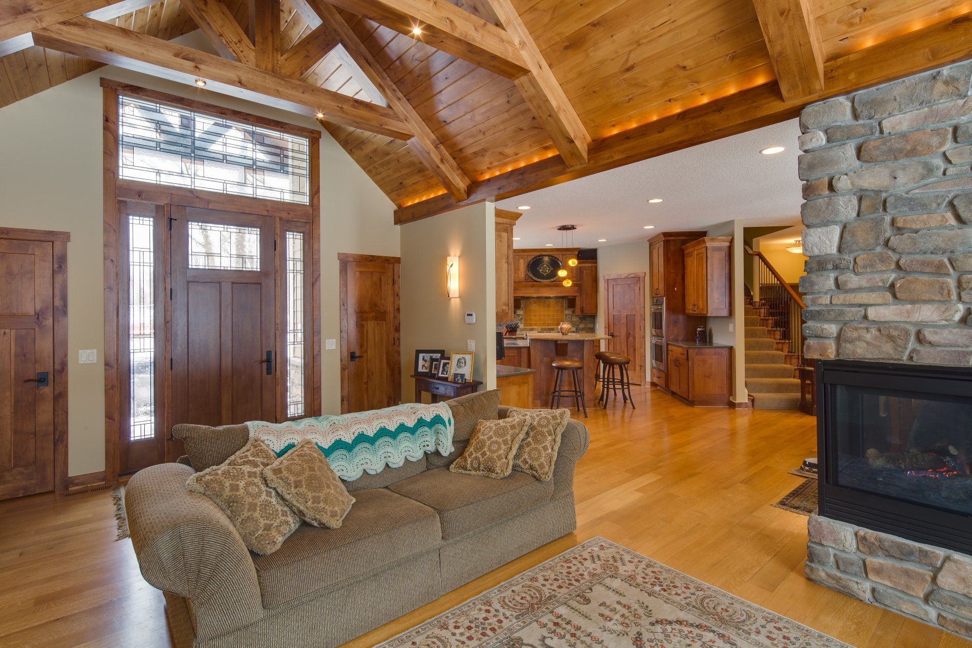 A living room with a couch and a fireplace in a house.