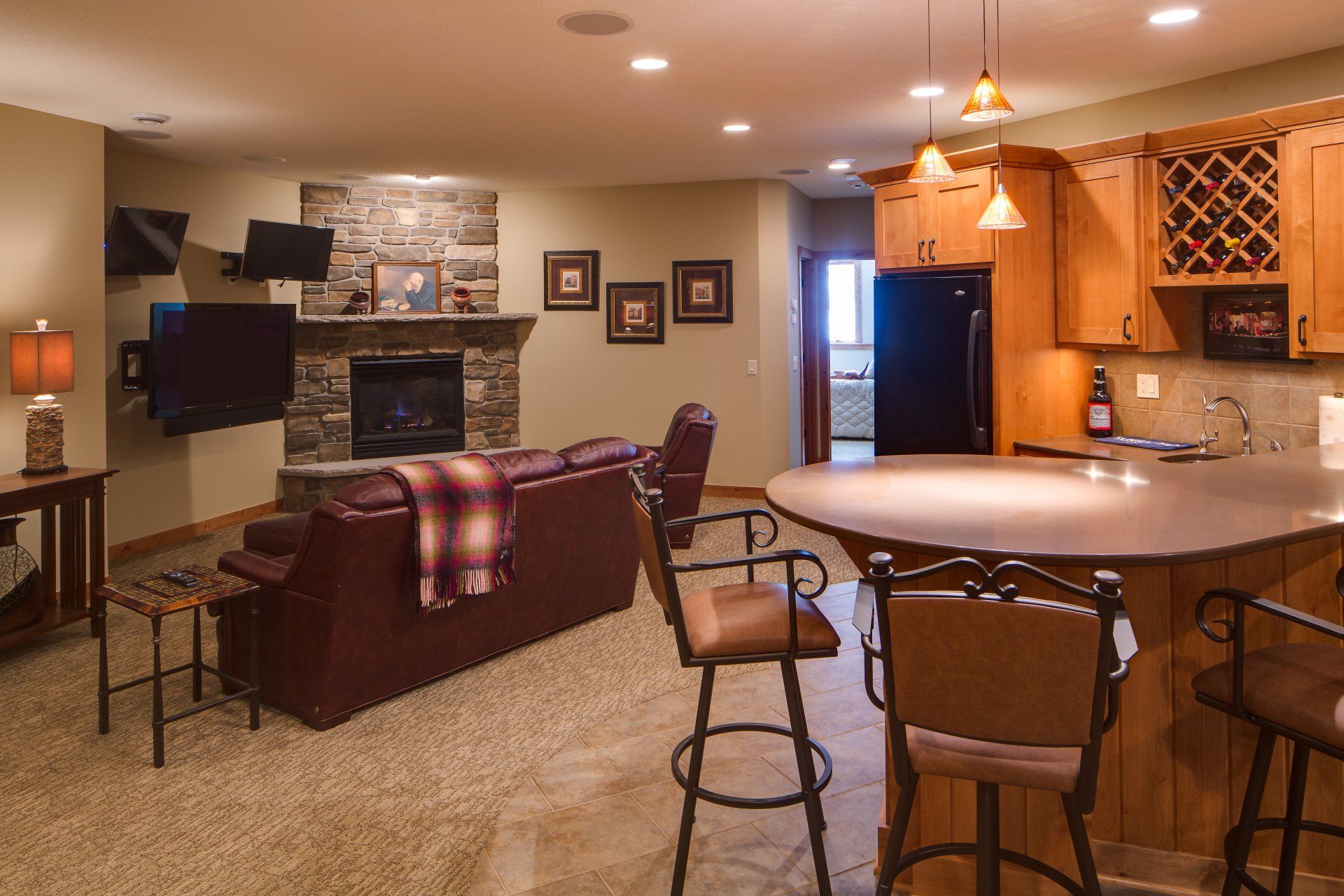 A living room with a fireplace and a bar