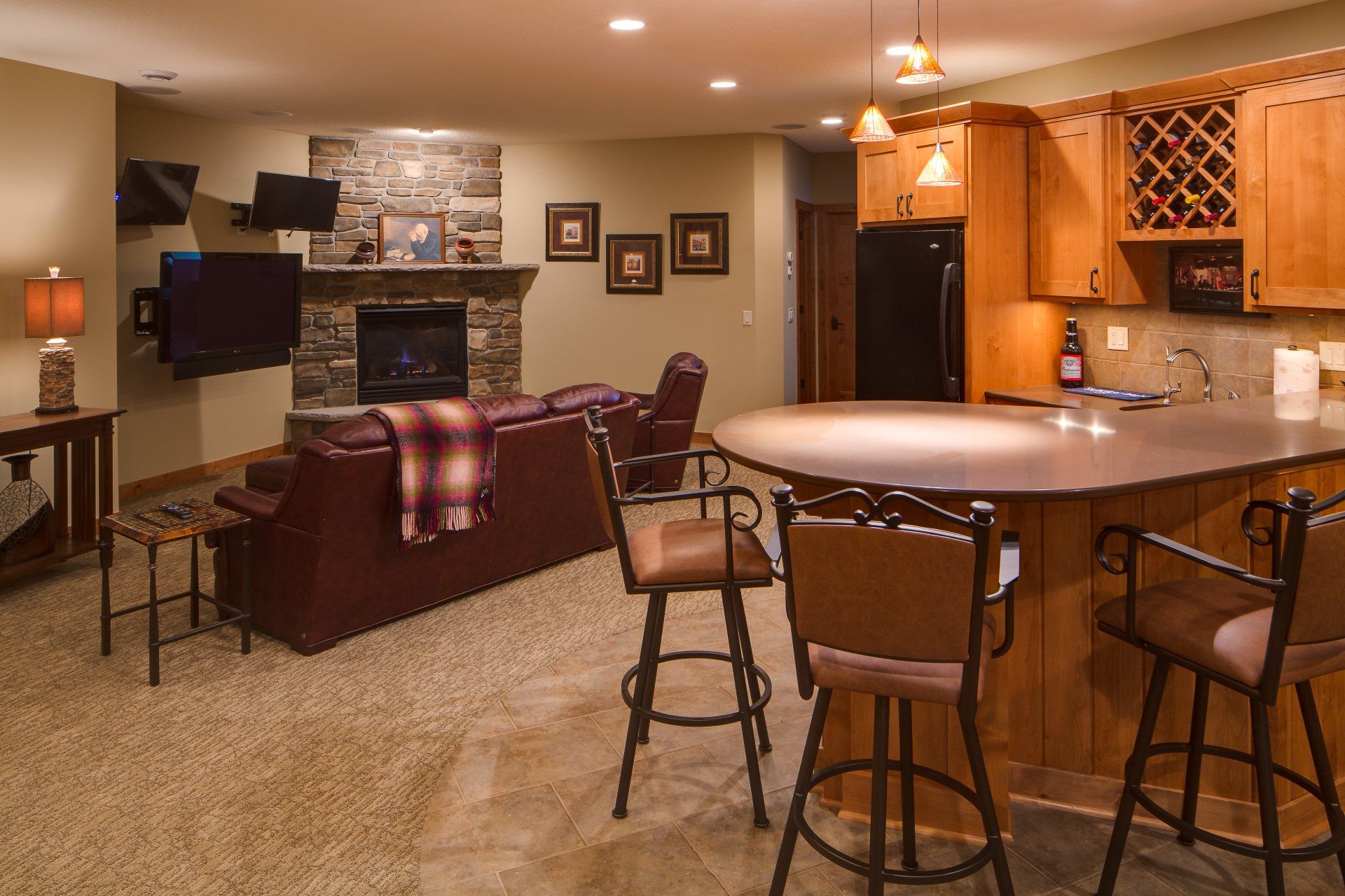 A living room with a fireplace and a bar