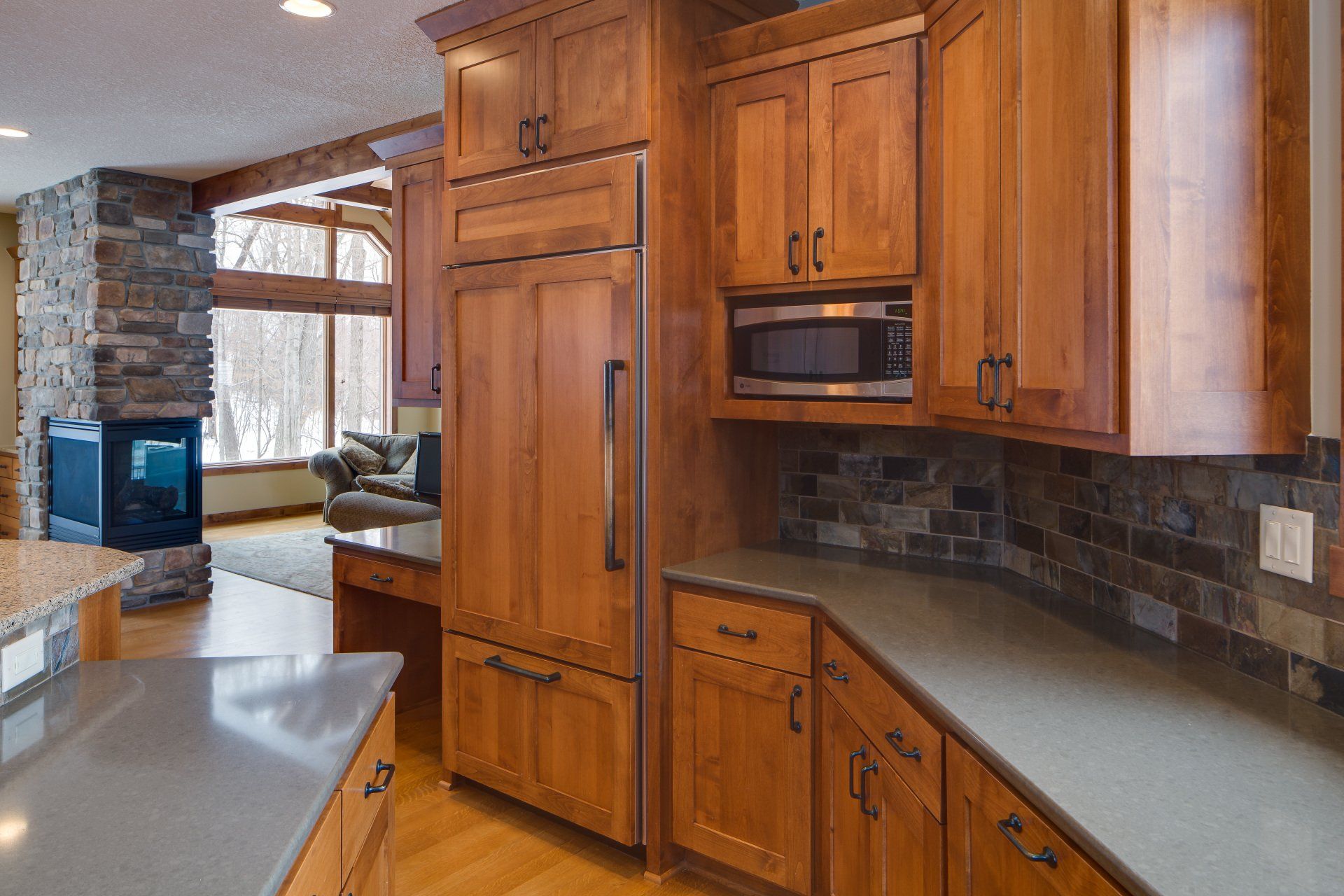 A kitchen with wooden cabinets and granite counter tops