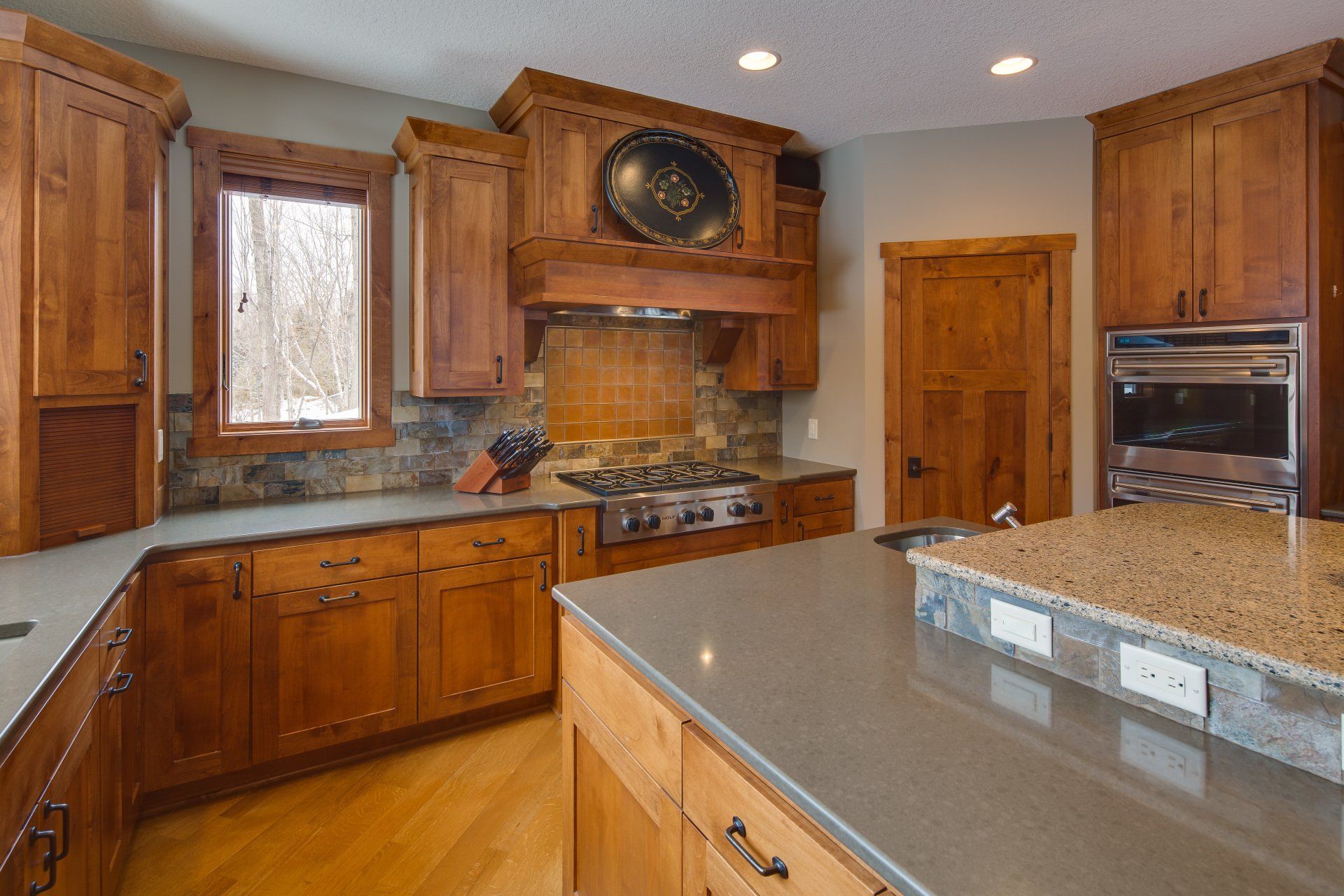 A kitchen with wooden cabinets and granite counter tops