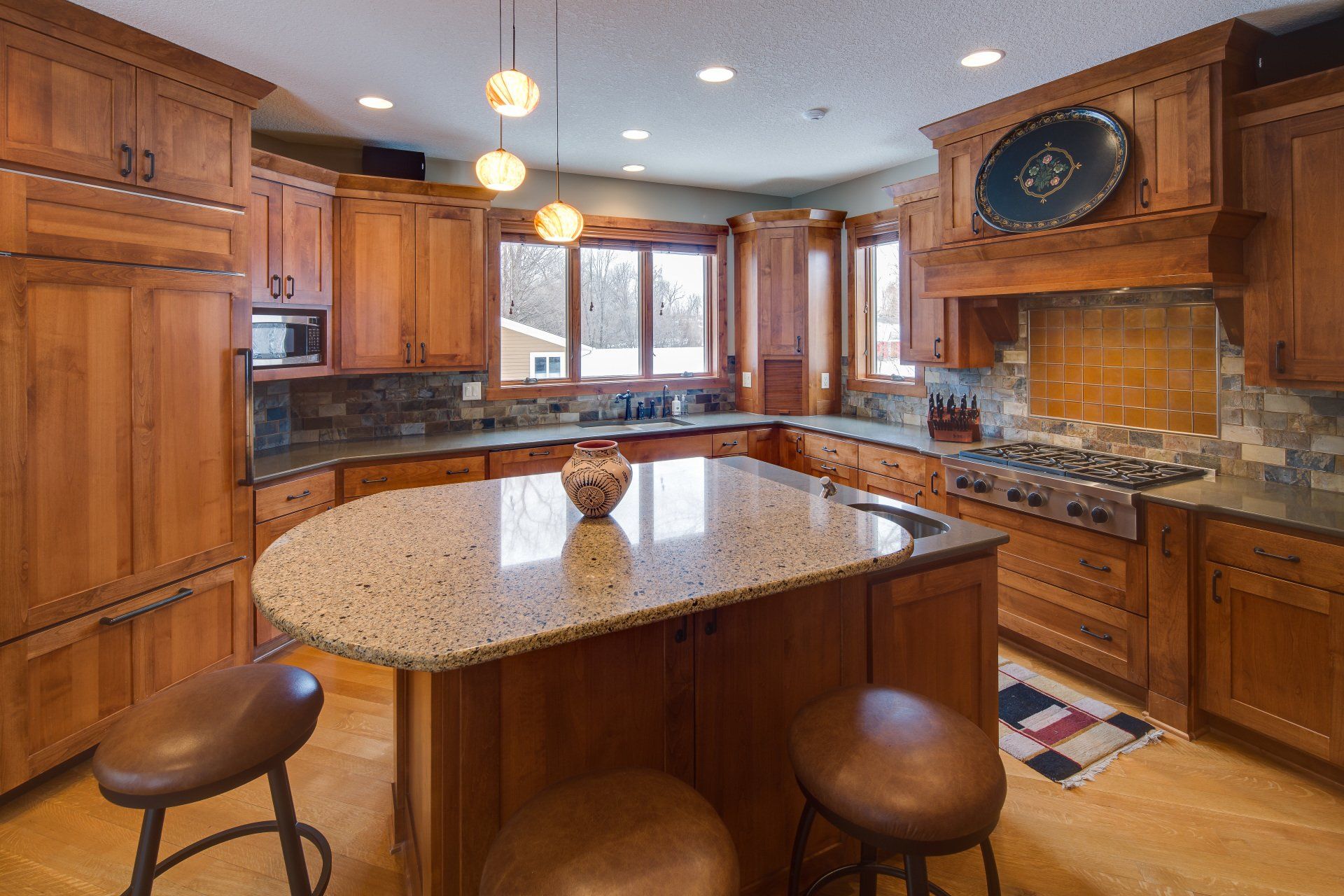 A kitchen with wooden cabinets and granite counter tops