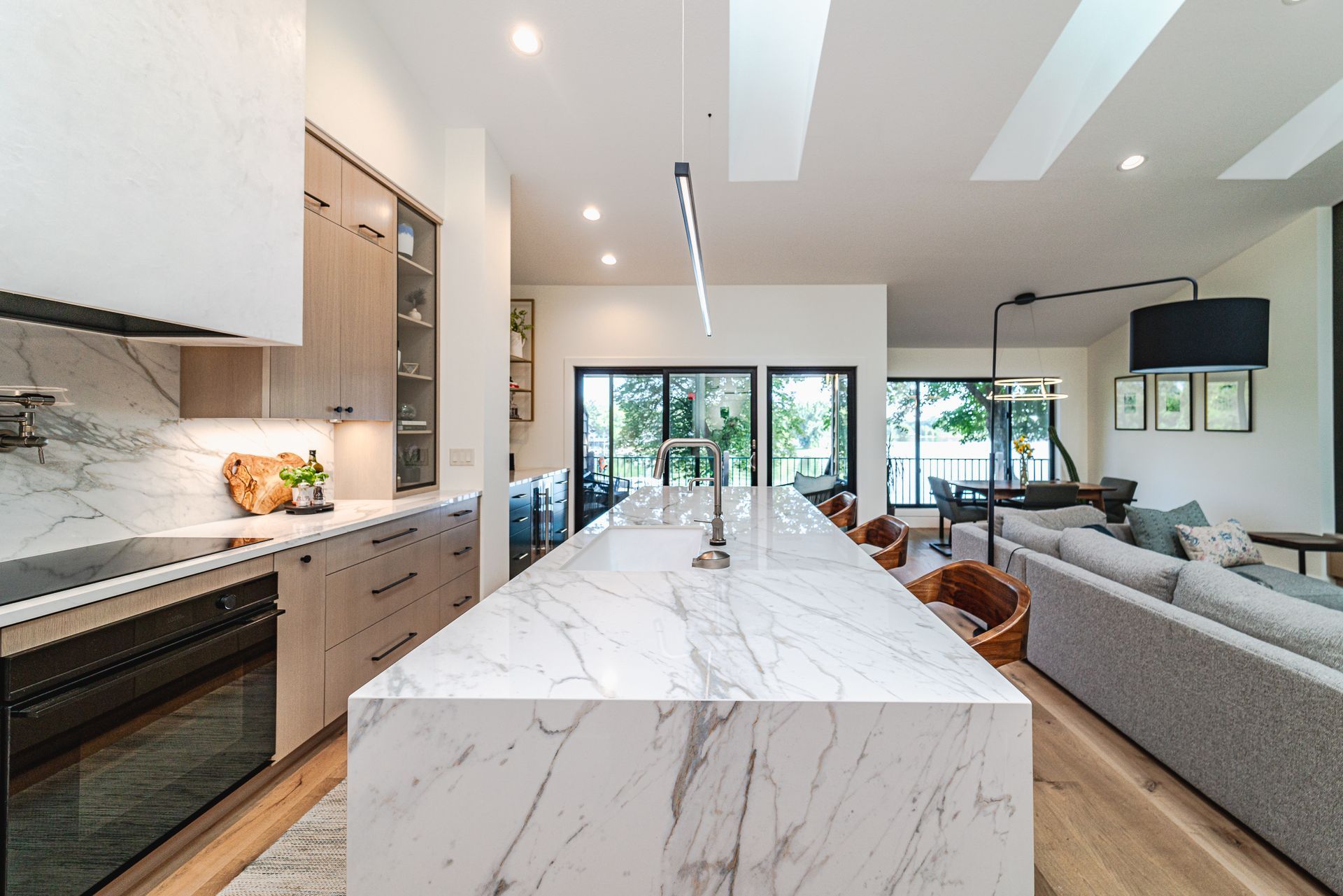 A kitchen with a large marble island in the middle of it