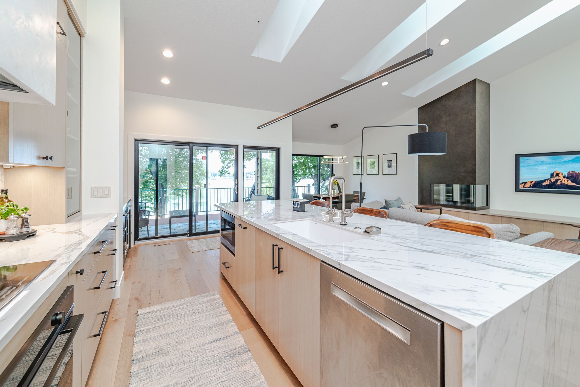 A kitchen with marble counter tops and stainless steel appliances