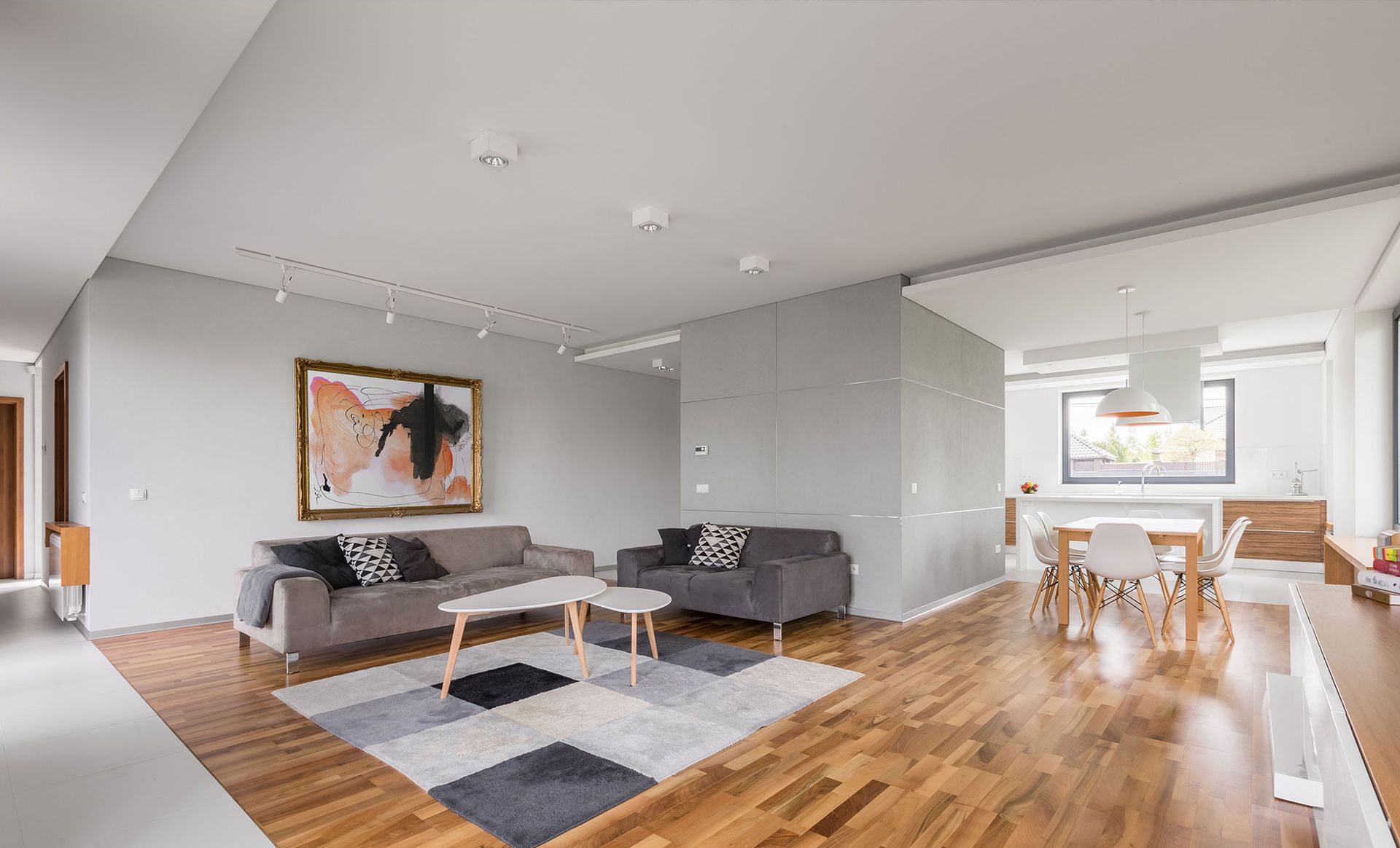 Two workers remodel a bathroom. One works on the tub, the other on fixtures. Pale walls and ceiling, neutral tones.