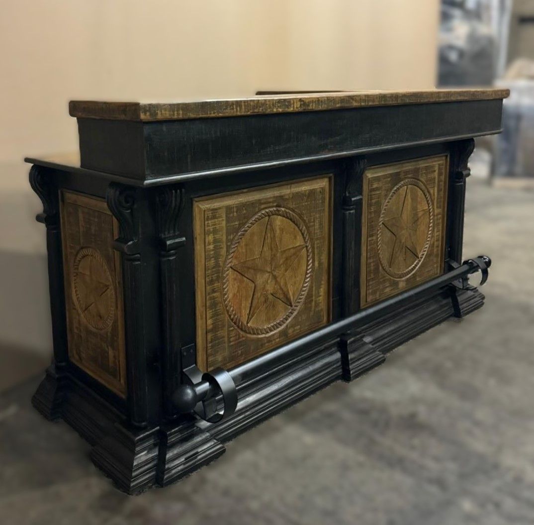 A rustic bar with a black frame, gold star panels, and a wooden countertop.