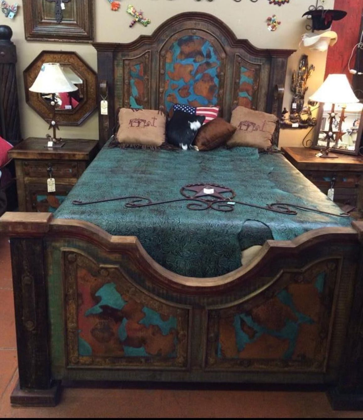 Rustic wooden bed frame with turquoise and copper accents, matching nightstands, and patterned bedding.