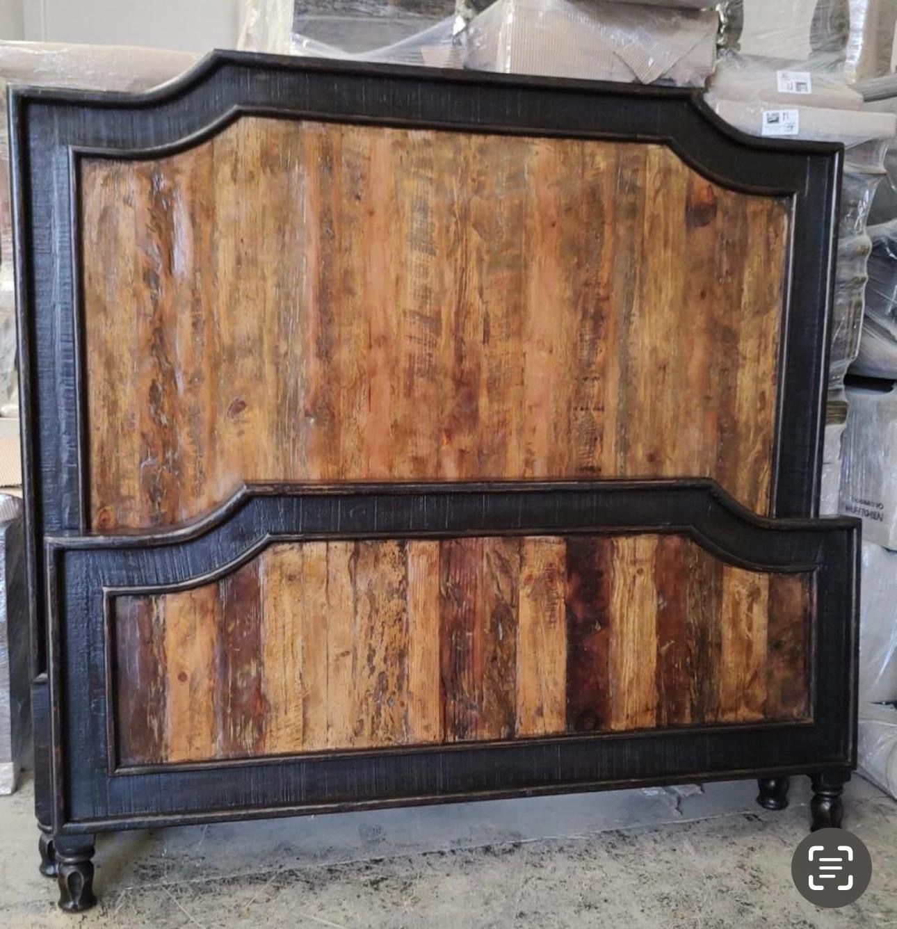 Rustic wooden bed frame with a dark border and multicolored vertical planks.