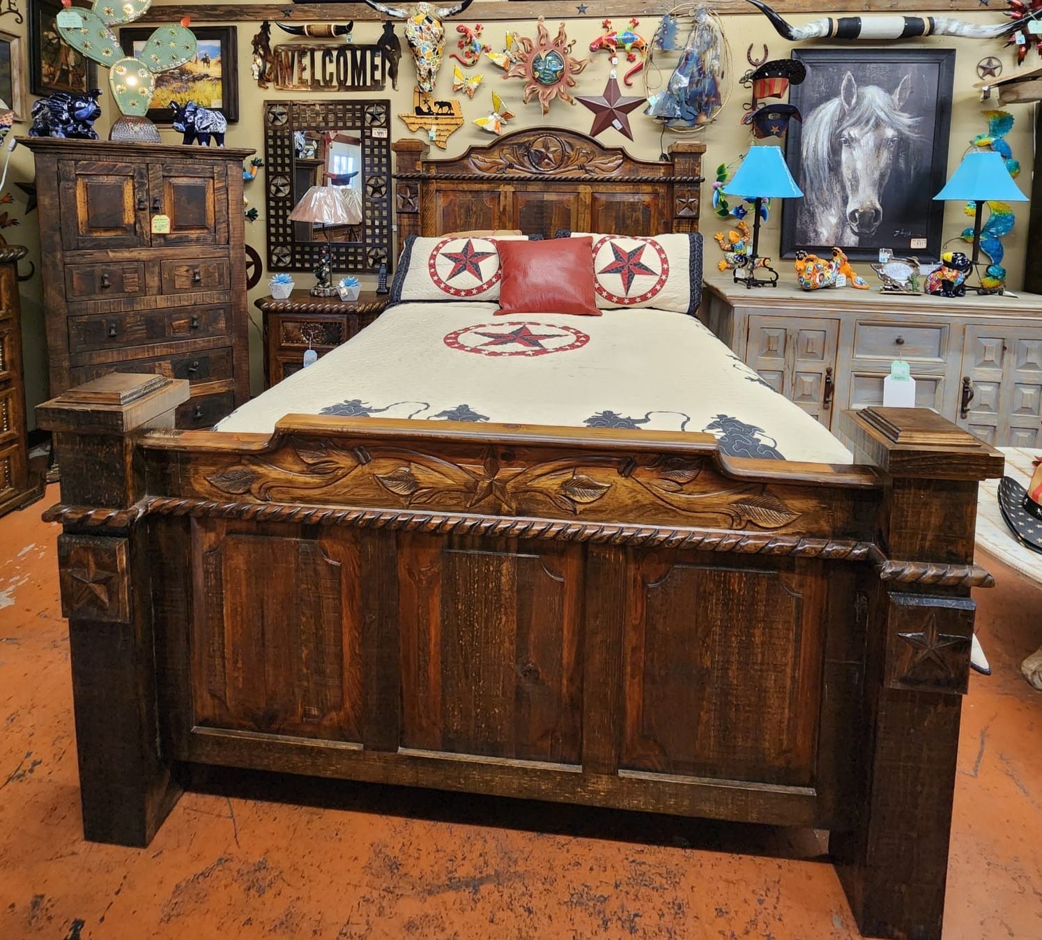 Wooden rustic bedroom set with carved headboard, bed frame, dresser, and nightstand, displayed in a store setting.