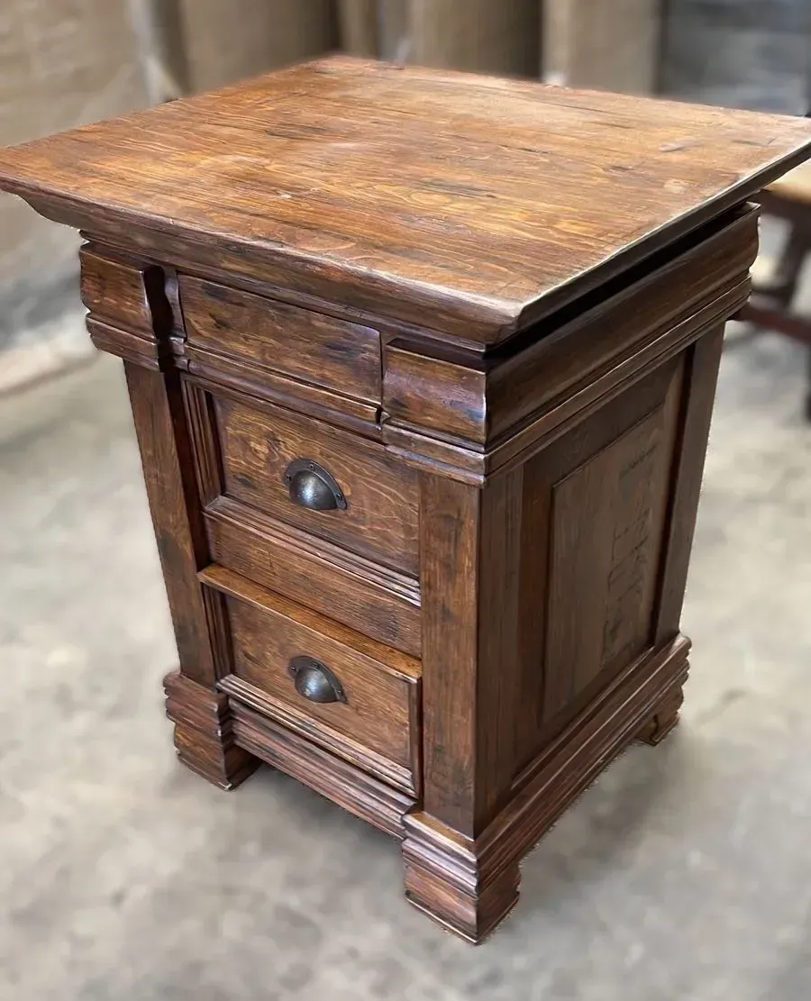Wooden nightstand with two drawers, dark finish, and decorative trim. Top surface appears aged and weathered.