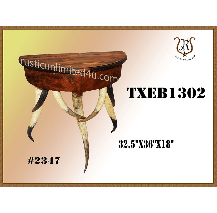 A rustic, half-moon shaped wooden table with three legs. The legs are painted with alternating black and white streaks.