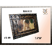 Ornate wooden picture frame, black with bronze accents, holding a photo. 7.5x9.