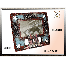 Ornate, square picture frame with a faded image visible. The frame is brown with blue accents, and features decorative swirls and cutouts.