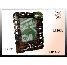 A brown, Western-style photo frame with a picture of a rider on a horse. Embellishments include roping and turquoise accents.