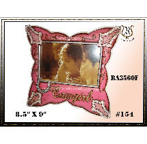 Pink butterfly-shaped photo frame holding a photo of a child. Includes decorative accents and text reading every girl.